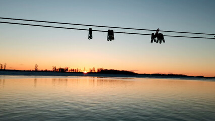 Beautiful sunset and blue sky over a forest lake at evening. Clip. Gentle lake ripples and ropes...