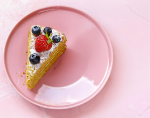 honey cake dessert on a plate on a pink background