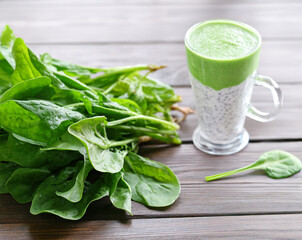 spinach smoothie and fresh spinach on the table