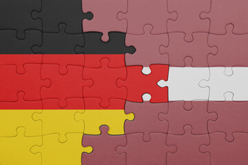puzzle with the colourful national flag of latvia and flag of germany.