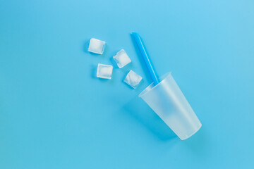 Disposable cup with ice and straw for cocktails. Cold drink concept