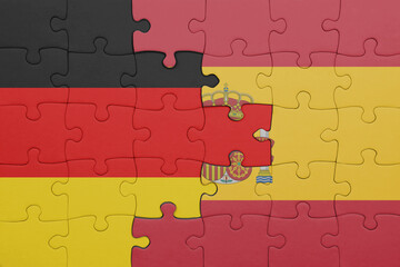 puzzle with the colourful national flag of spain and flag of germany.