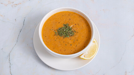 Lentil soup bowl isolated and lemon slice