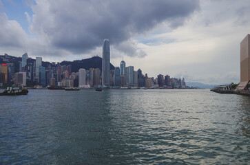 Fototapeta premium Panoramic skyline silhouette view of Hongkong Hong Kong Victoria Harbor and port infrastructure bay scenic landscape seascape scenery during twilight blue hour in China