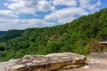 Sandstone cliffs, surrounded by heavily forested mountainside, are visible from the Great Stone...