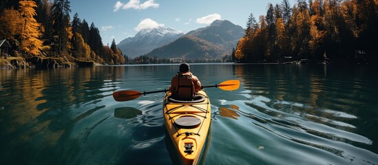 landscape photo of Man with canoe on lake