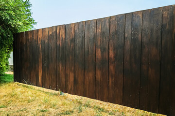 Brown wood plank wall texture background. Surface of teak wood background fence in garden. Wooden...