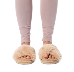 Woman in beige fluffy slippers on white background, closeup