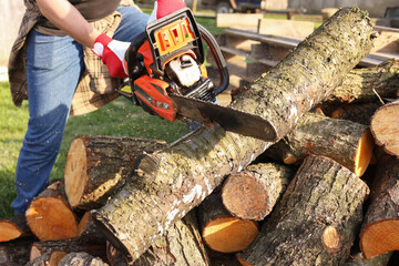 Man sawing wood on sunny day, closeup view