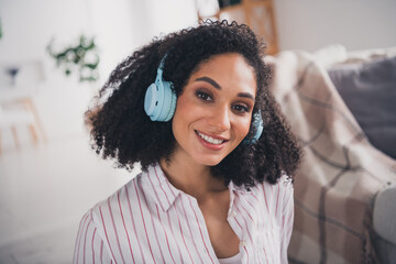 Photo of good mood shiny woman dressed striped shirt headphones enjoying music indoors house...