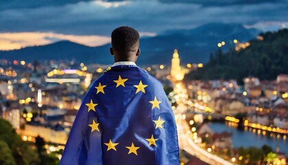 man stands backwards with a developing European flag on her shoulders, against a blurred background of a night city