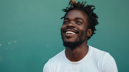 Attractive African American man portrait. Handsome smiling black guy. Happy mixed race person face. Young adult teenager. Cool stylish teen. Fashionable ethnic 20s student at green background.