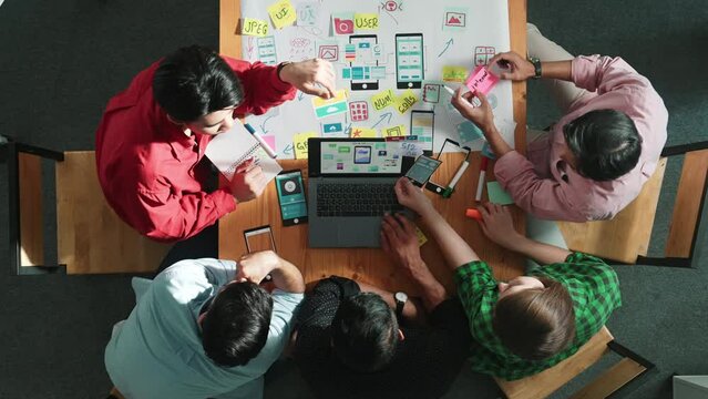 Top view of manager design Ux Ui designing for mobile phone and stick on whiteboard. Startup business team working together by using mind map sharing idea and writing plan in sticky note. Convocation.