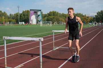 Obraz premium Young sporty man athlete runner in sportswear stretching