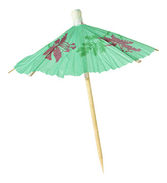 Green cocktail umbrella. Decoration concept with picture of colourful green cocktail paper decorative umbrella isolated