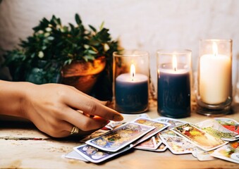 Tarot reading by candlelight, cards on the table