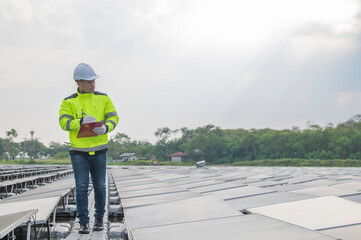 Engineer working at floating solar farm,checking and maintenance with solar batteries near solar...