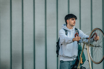 urban scene of young man with vintage bicycle