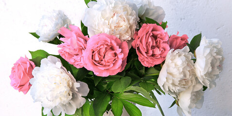 Bouquet of peonies and roses on a table