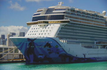 Big modern cruiseship or cruise ship liner Bliss in Port of Miami, Florida with downtown skyline...