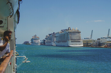 Big modern cruiseship or cruise ship liner Bliss in Port of Miami, Florida with downtown skyline...