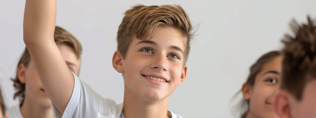 Lively high school classmates, their expressions animated as they participate in a lesson, a smiling, confident Caucasian boy leading the charge to answer the teacher's query.