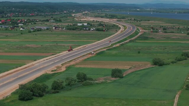 Romania A1 highway construction site. Aerial 4k video of A1 road that connects Bucharest Pitesti highway with Curtea de Arges and Sibiu. Infrastructure construction industry in Romania.