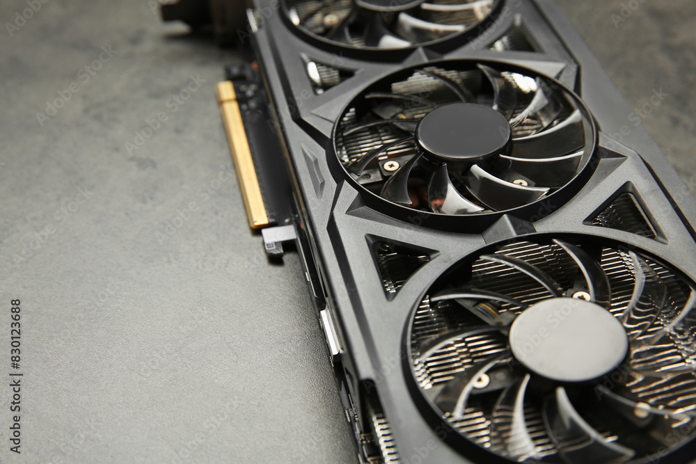 Fototapete one computer graphics card on grey textured table, closeup. space for text