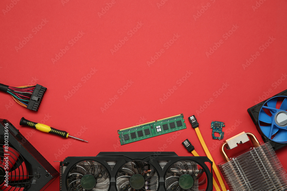 Fototapete graphics card and other computer hardware on red background, flat lay. space for text
