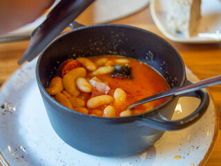 fabada dish served in a cocotte pot