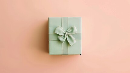 A charming gift box wrapped in pastel green paper, strategically placed on a soft pastel peach background, highlighting the golden ratio