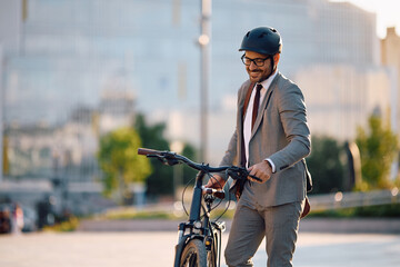 Happy businessman going to work by bicycle.