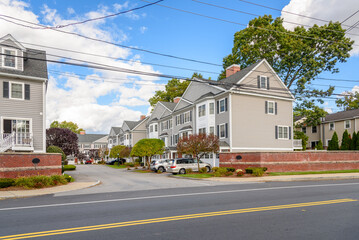 Rows of new townhouses in a housing development under blue sky in autumn