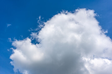White fluffy clouds in front of a blue sky