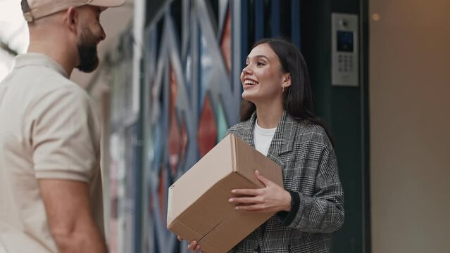 A doorstep exchange as a customer receives a package from a delivery man, capturing the convenience of home delivery services and the satisfaction of receiving an order.