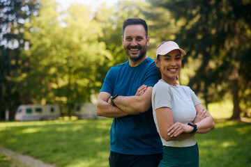 Portrait of confident sports couple in nature looking at camera.