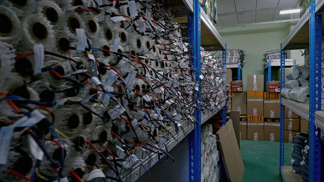 A large warehouse of products in rolls. Creative. Moving along shelves in storage house.