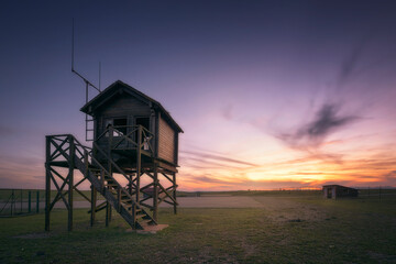 Sunset at the abandoned La Lora airfield in Valderredible, Cantabria, with the control tower in the...