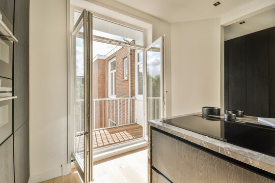 Modern kitchen leading to a bright balcony space