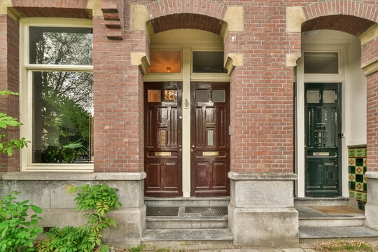Ornate brick house facade with elegant doors