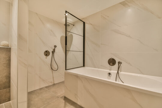 Elegant modern bathroom with marble tiles and glass shower