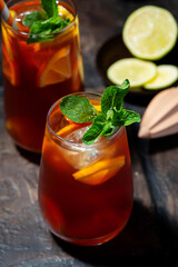 glass of iced tea with lemon and fresh mint, top view