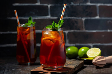 iced tea with lemon and fresh mint on dark background