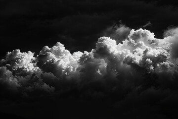 Black and white photo of dark clouds in the sky, taken from a low angle. The cinematic monochrome...
