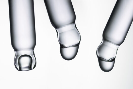 Close-up view of cosmetic pipettes with liquid drops