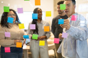 Diverse Team Brainstorming With Sticky Notes In Office