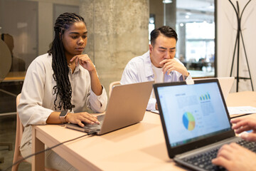 Diverse colleagues focused on work at coworking space