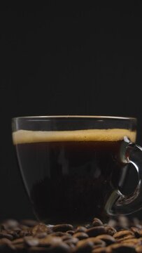 Gourmet Moment: Coffee Cup Among Roasted Beans in Slow-Mo