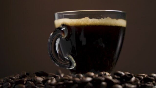 Smooth Slide: Coffee Cup on Roasted Beans in Slow-Motion