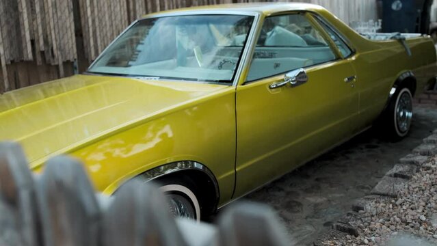 Lowrider Car in front Yard, Yellow Gold Metallic Paint, Chrome Wheels